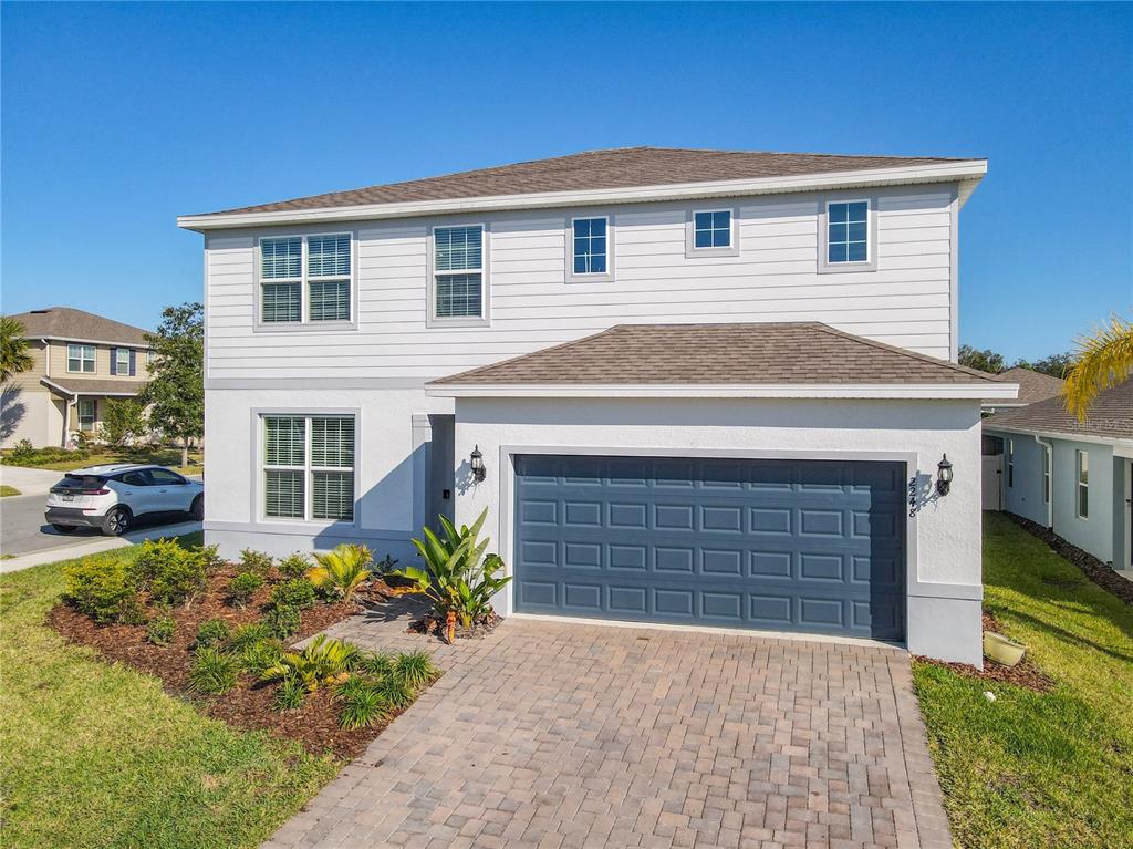 An aerial view of a two-story suburban house with a paved driveway and corner lot — 2248 CANOPY TERRACE BOULEVARD, DELAND, FL