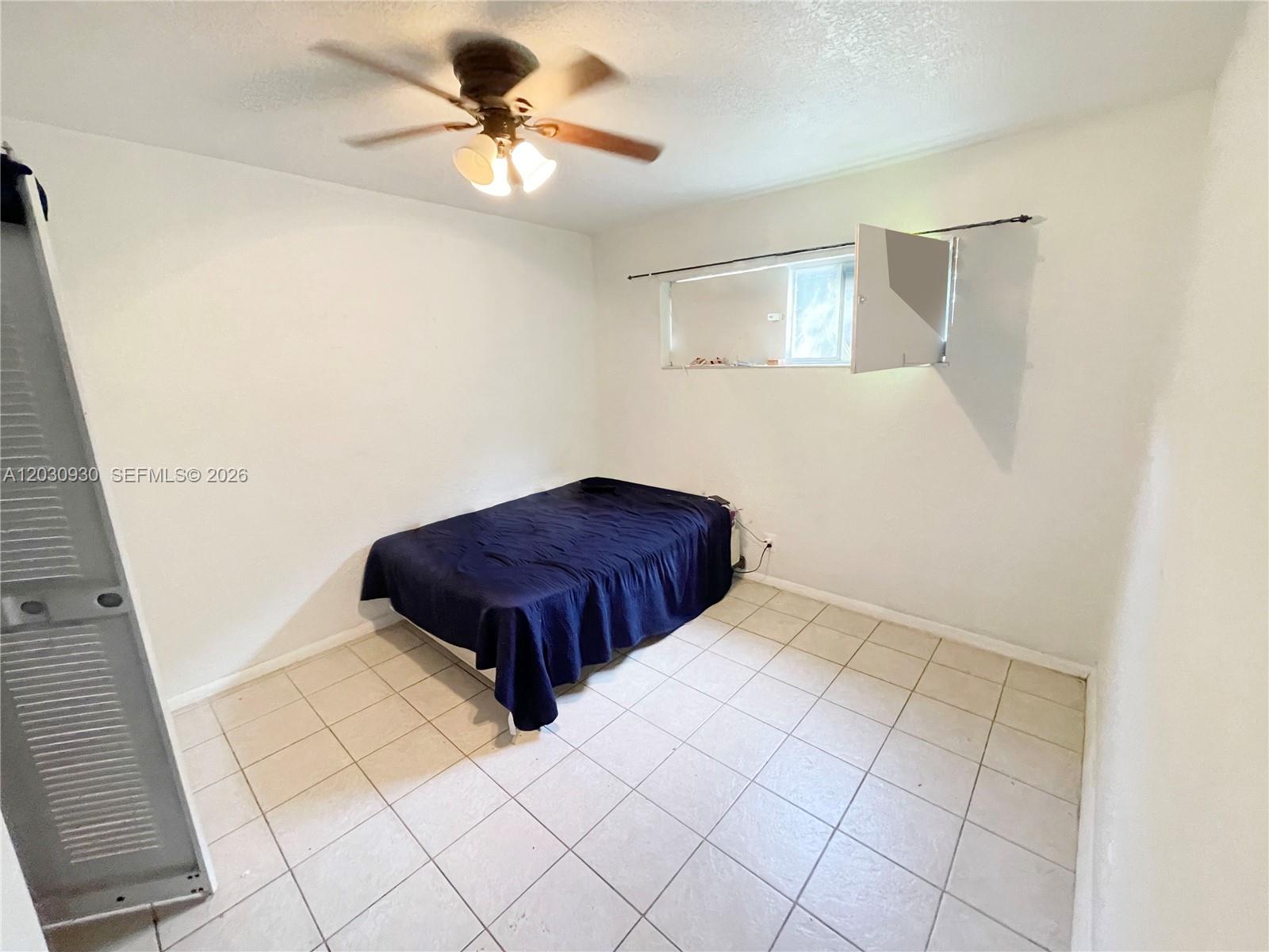 A bedroom features white walls, a tiled floor, a ceiling fan, and a single bed — 1829 N A St # 51, Lake Worth FL 33460, LAKE WORTH, FL