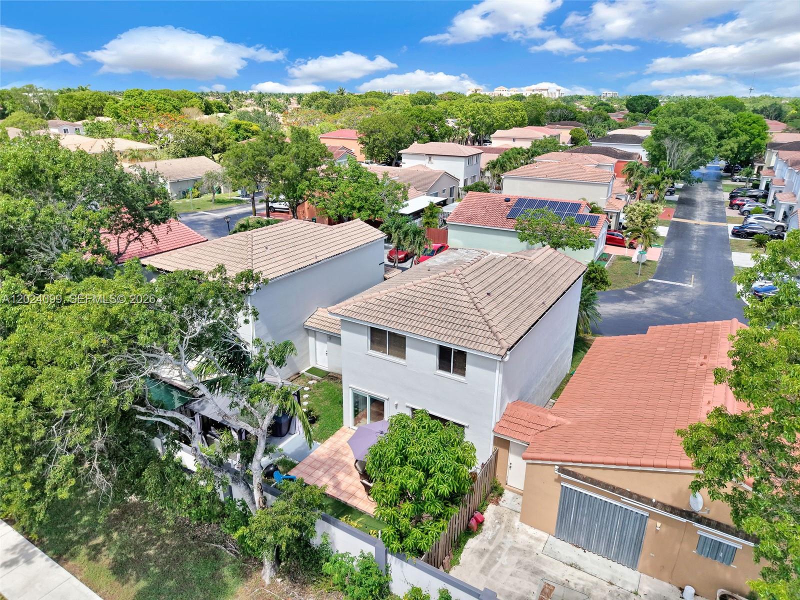 An aerial view shows a two-story house with a tiled roof and a backyard patio — 9732 SW 166th Ct, Miami FL 33196, MIAMI, FL