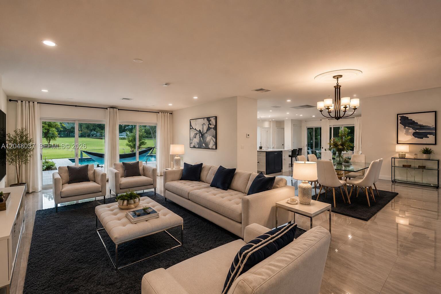 A living and dining area features a tufted sofa, glass-topped table, and sliding glass doors — 4740 N 31st Ct, Hollywood FL 33021, HOLLYWOOD, FL