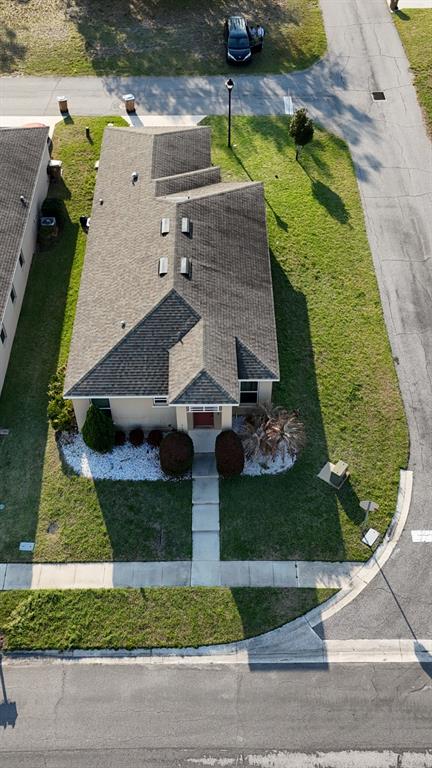 An aerial view shows a single-story house with a shingled roof and a front walkway — 3100 ROCKY RIVER ROAD, KISSIMMEE, FL