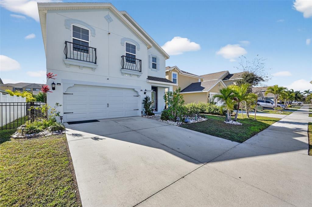 A two-story house with a white exterior, a two-car garage, and a concrete driveway — 4842 SAN PALERMO DRIVE, BRADENTON, FL