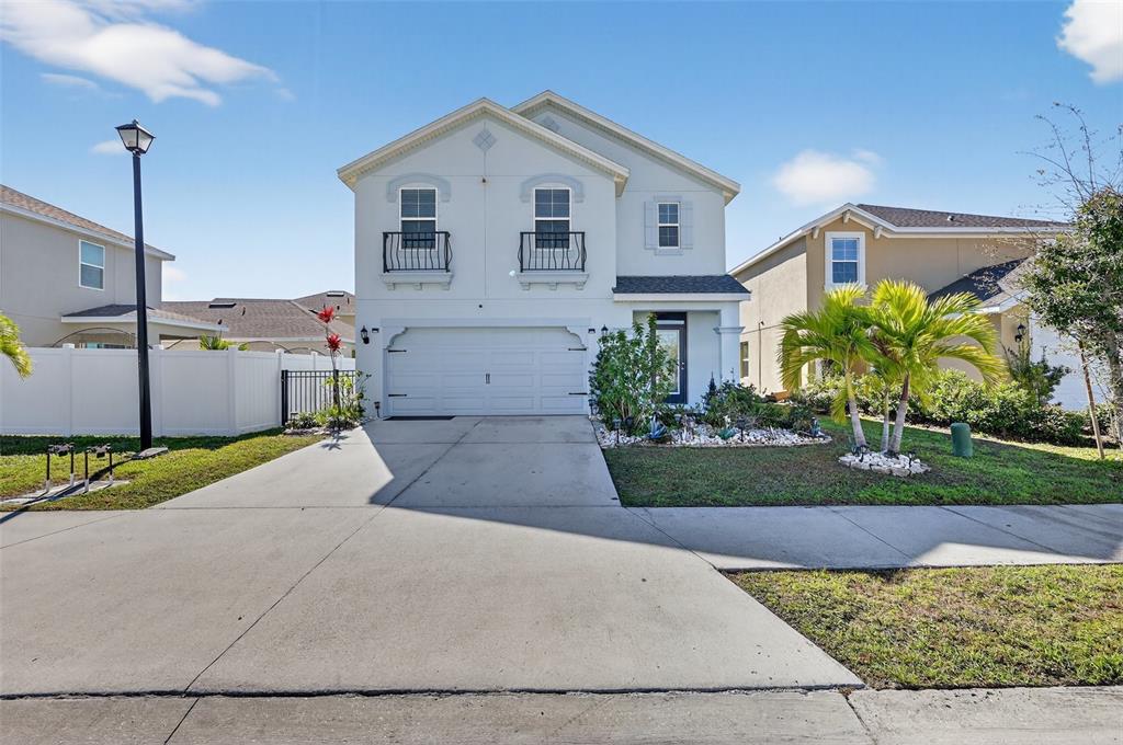 A two-story house with a white exterior, a two-car garage, and a concrete driveway — 4842 SAN PALERMO DRIVE, BRADENTON, FL