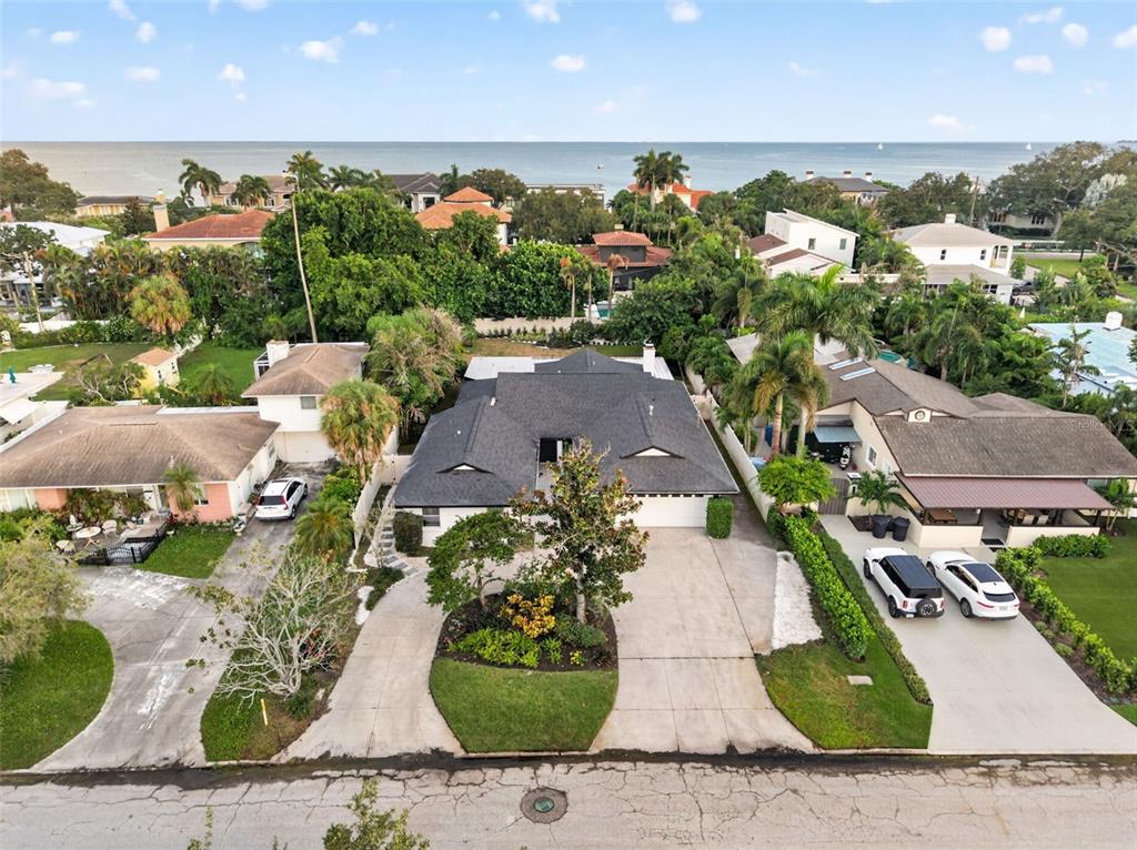 An aerial view shows a single-story house with a dark roof and a circular driveway — 219 MIRAMAR BOULEVARD NE, ST PETERSBURG, FL