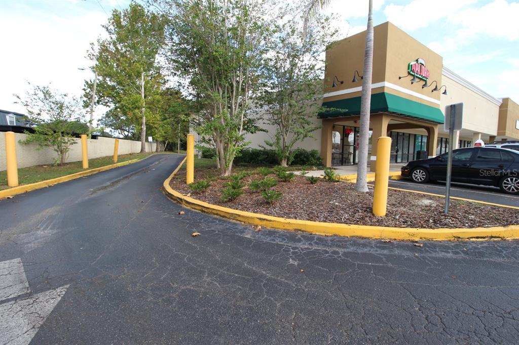 An exterior view of a commercial building with a Papa Johns sign and parking lot — 1740 STATE ROAD 436, WINTER PARK, FL