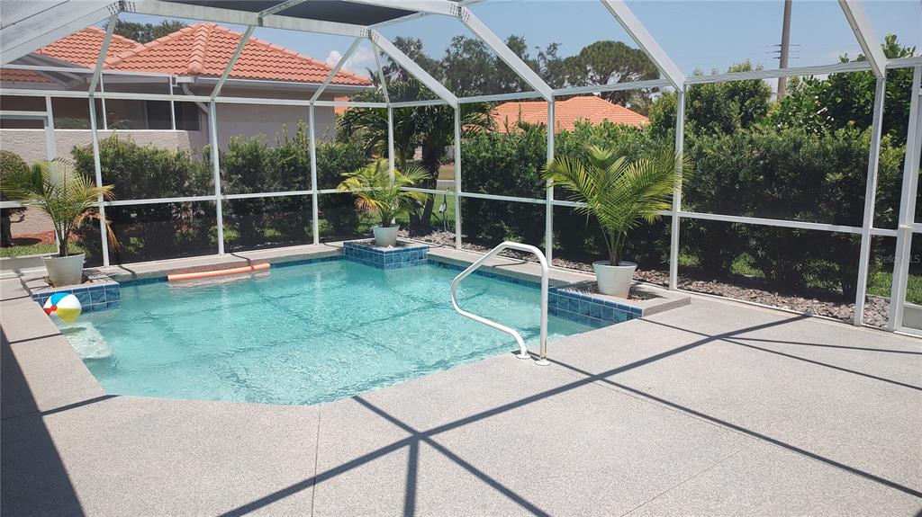 A screened-in swimming pool with a concrete deck and potted palm trees — 4835 JACARANDA HEIGHTS DRIVE, VENICE, FL