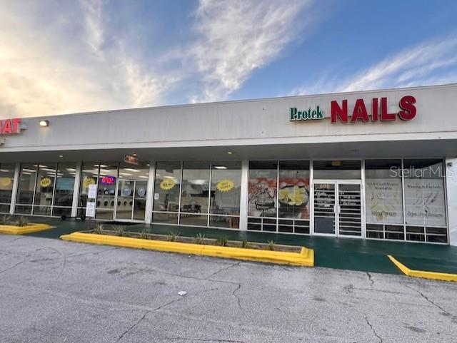 The exterior of a commercial strip mall features a storefront for Protek Nails — 600 S PARK AVENUE, TITUSVILLE, FL