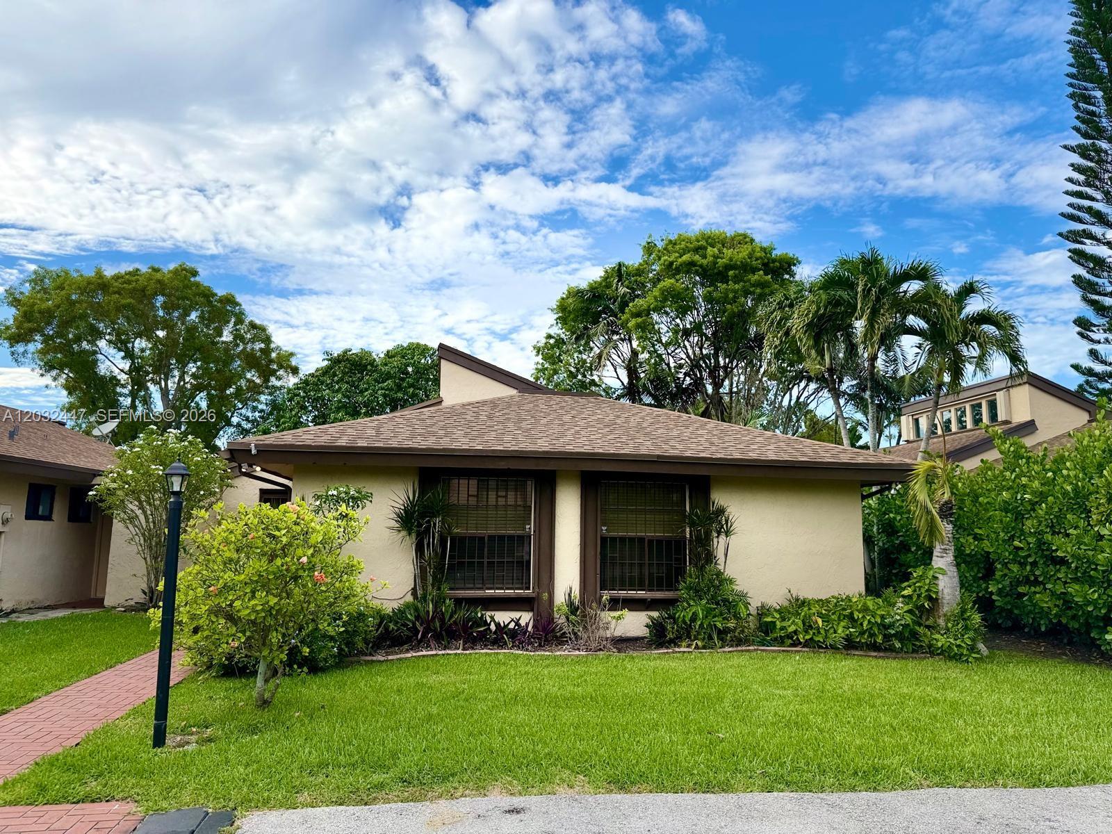 A single-story house with a brown shingled roof, beige stucco walls, and two front windows — 9119 SW 129th Ln # 0, Miami FL 33176, MIAMI, FL