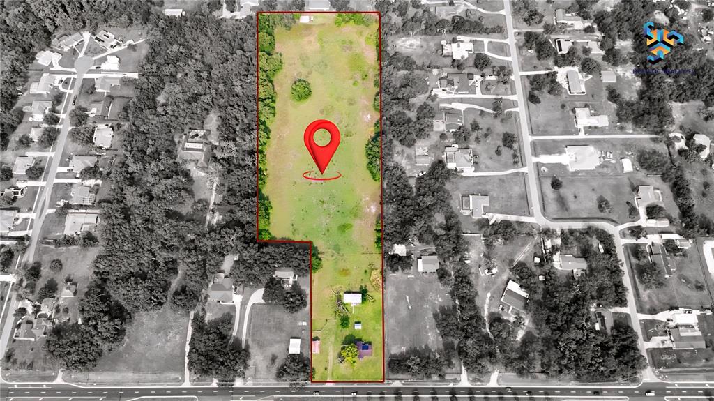 An aerial view shows a rectangular plot of land with a house and trees — 1886 PLEASANT HILL ROAD, KISSIMMEE, FL