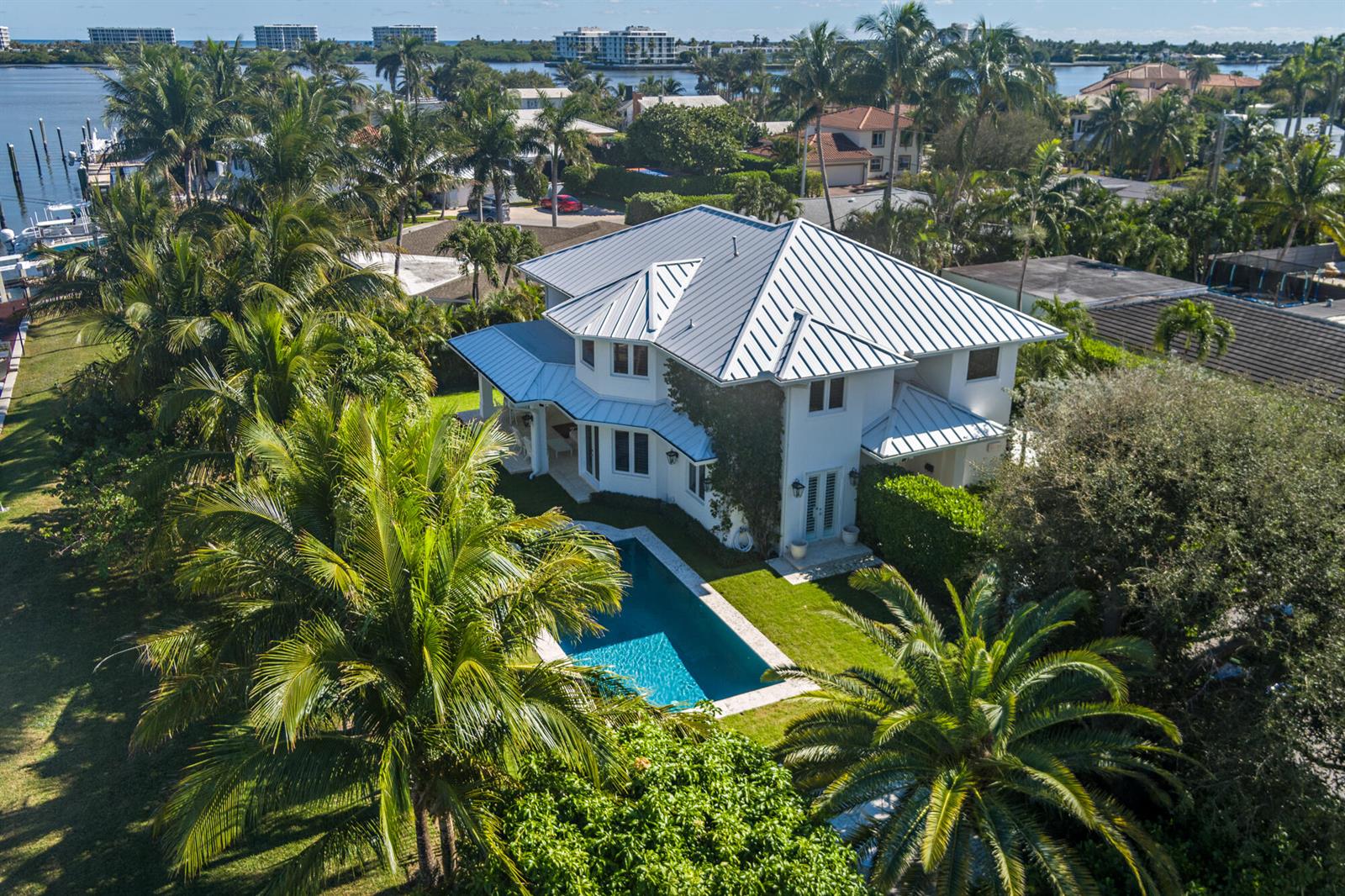 An aerial view of a white two-story house with a metal roof and swimming pool — 2614 Furman Lane, FL 33460, FL