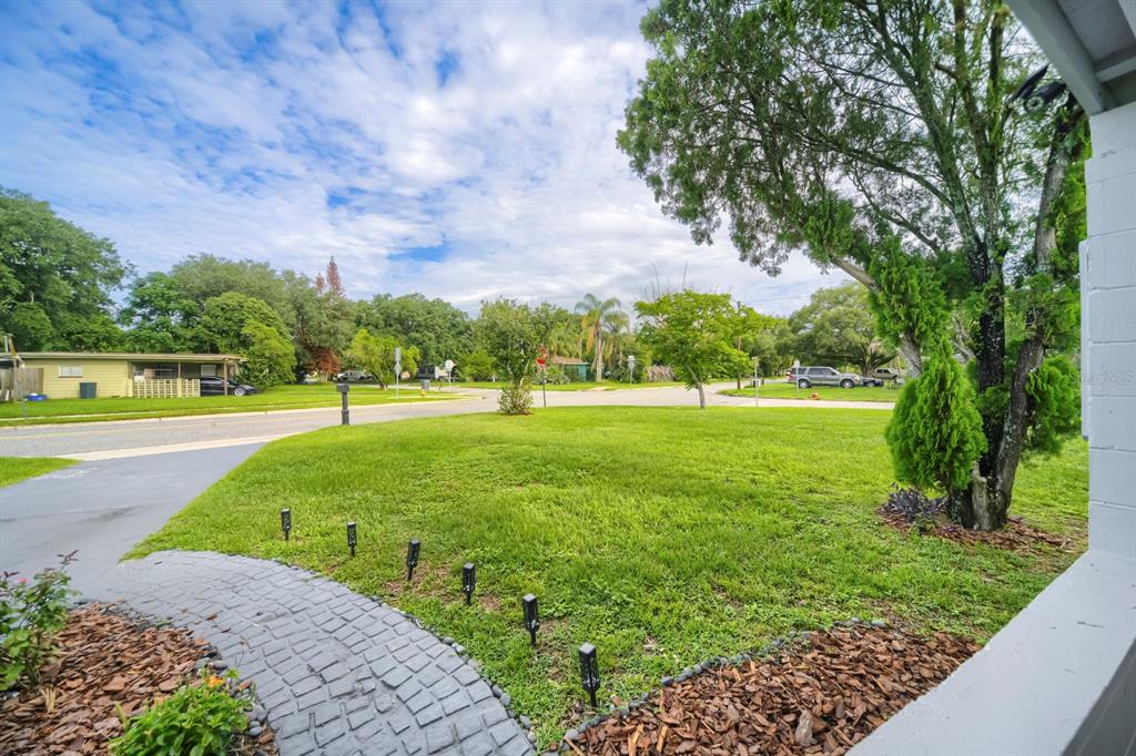 A view from a porch looking out over a grassy front yard toward a street — 201 HAYS DRIVE, SANFORD, FL