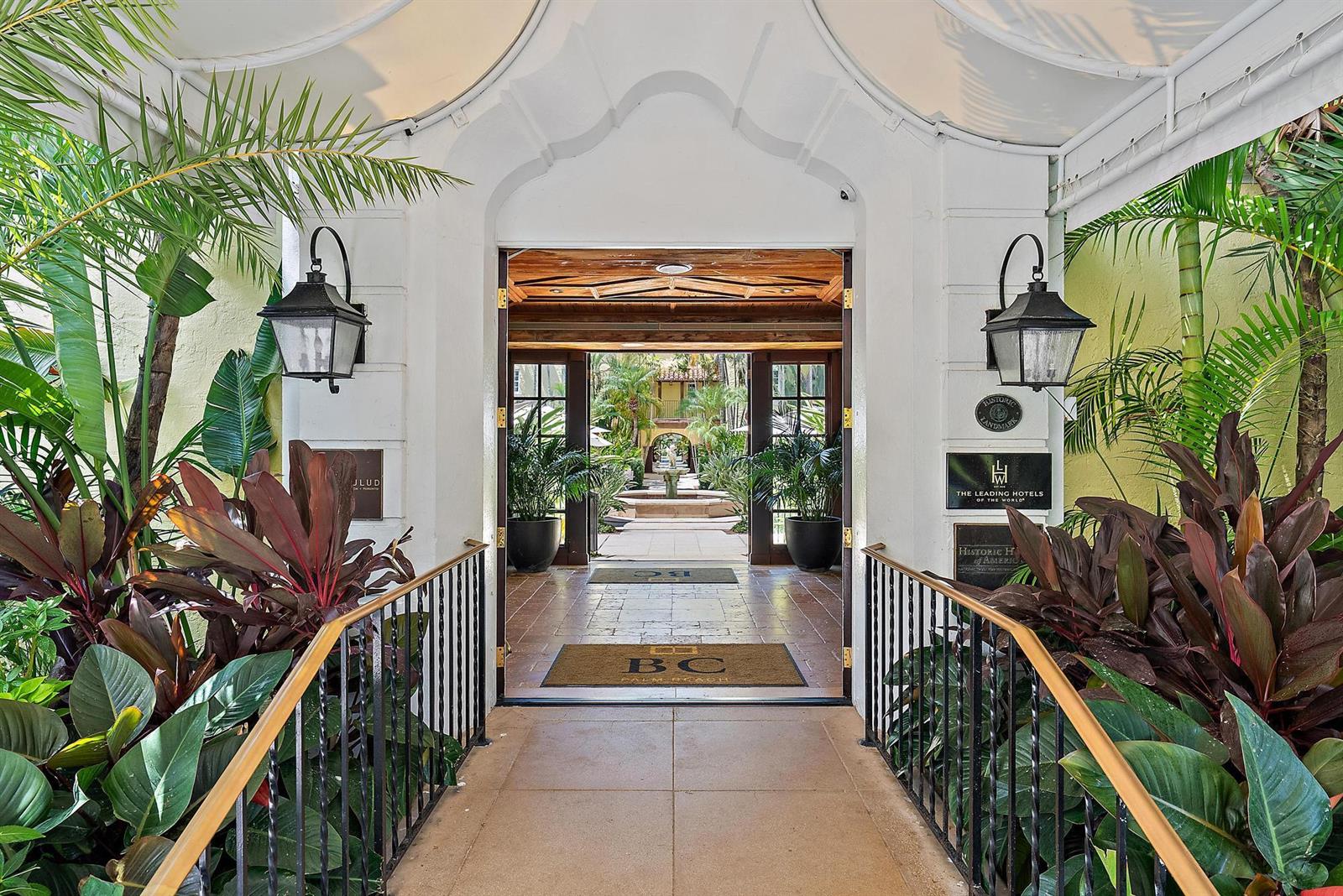 An arched entryway leads through a tiled corridor to an outdoor courtyard with a fountain — 301 Australian Avenue # 305, Palm Beach FL 33480, PALM BEACH, FL