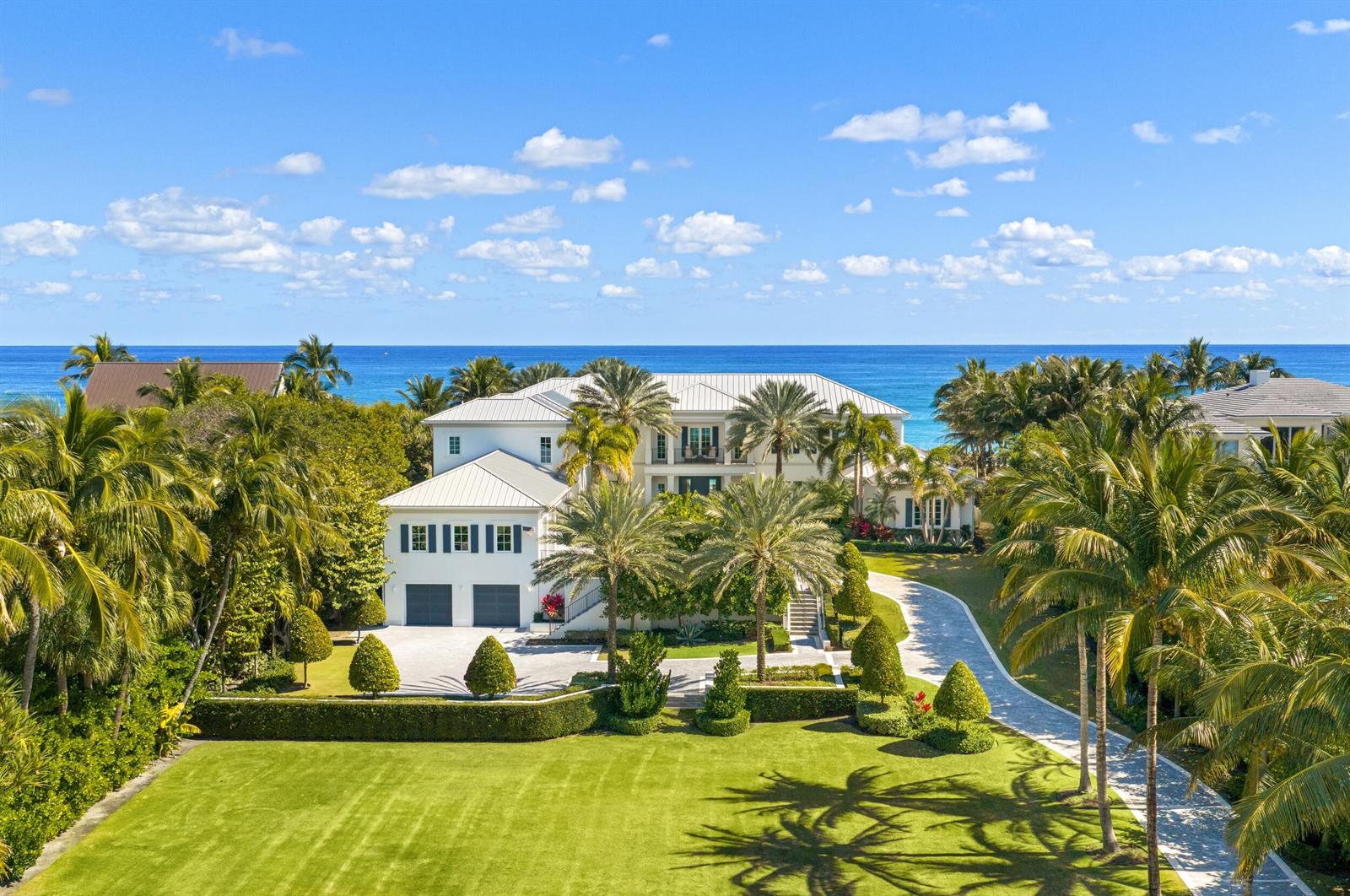 An aerial view of a large white house with a metal roof and palm trees — 900 S Ocean Boulevard, Manalapan FL 33462, MANALAPAN, FL