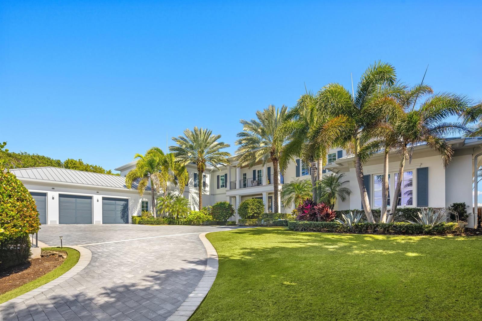A large two-story house with a three-car garage, palm trees, and a paved driveway — 900 S Ocean Boulevard, Manalapan FL 33462, MANALAPAN, FL
