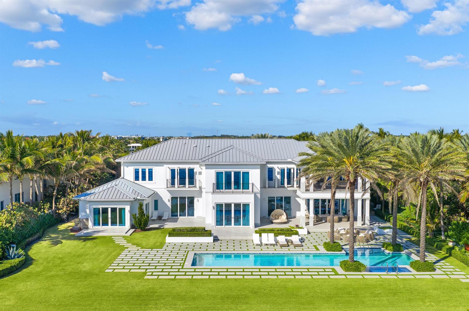 An aerial view of a large white two-story house with a pool and palm trees — 900 S Ocean Boulevard, Manalapan FL 33462, MANALAPAN, FL