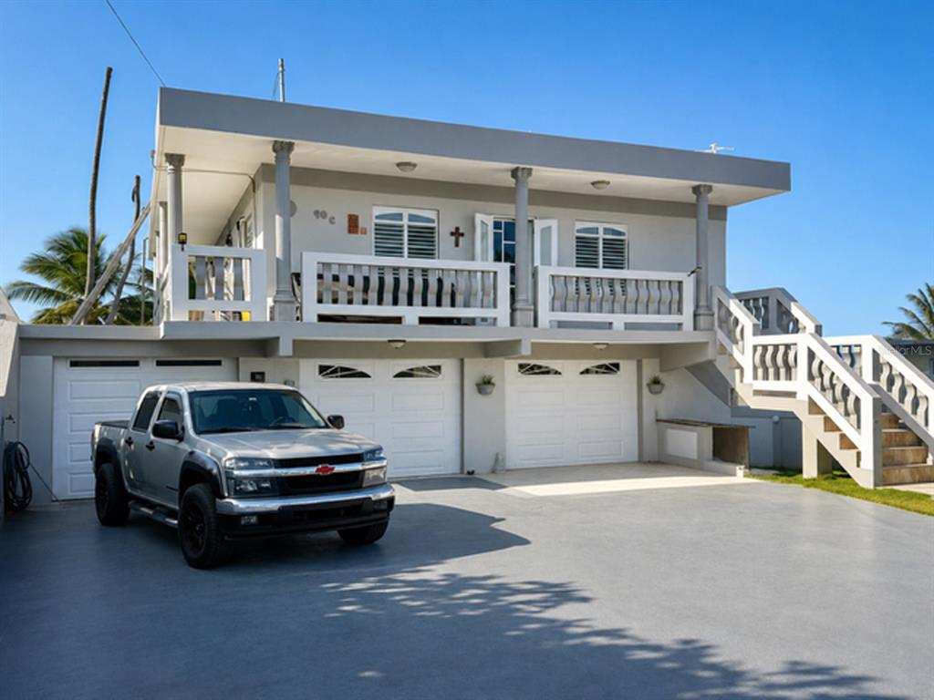 A two-story house with a gray exterior, a silver pickup truck, and an outdoor staircase — Mameyal EXT KENNEDY UNIT Mameyal wd, DORADO, PR