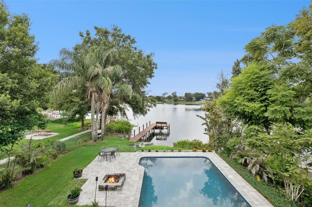 An elevated view of a backyard featuring a swimming pool, fire pit, and private dock — 2939 DAWLEY AVENUE, ORLANDO, FL