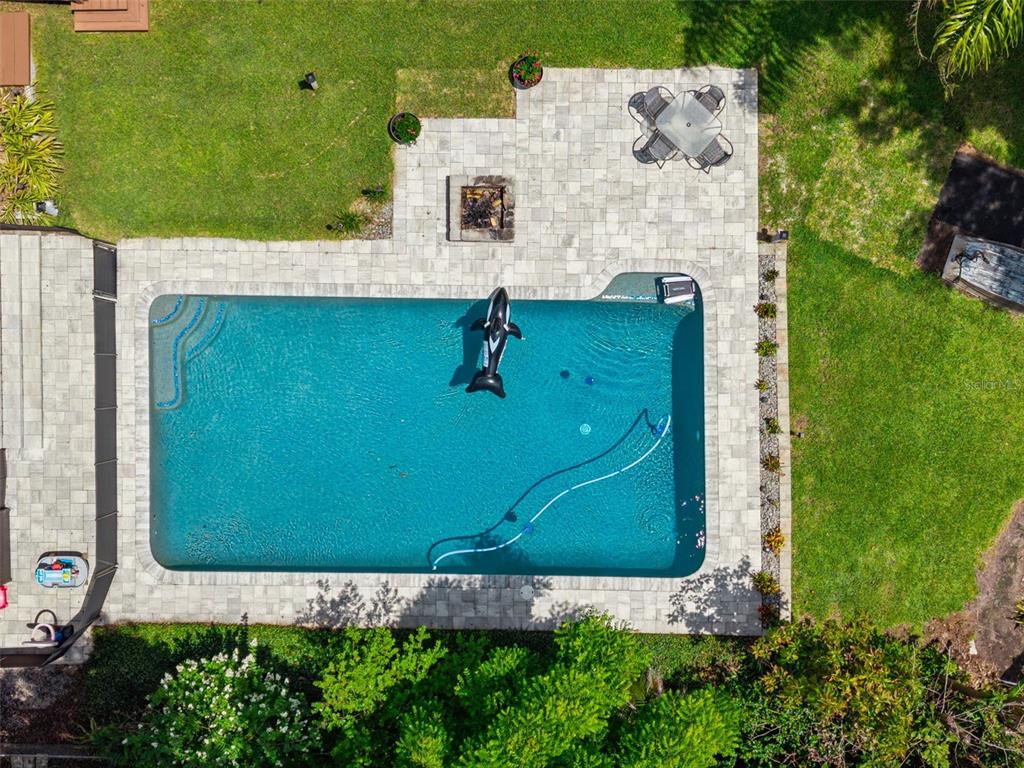 An aerial view shows a rectangular swimming pool with a patio, fire pit, and seating — 2939 DAWLEY AVENUE, ORLANDO, FL