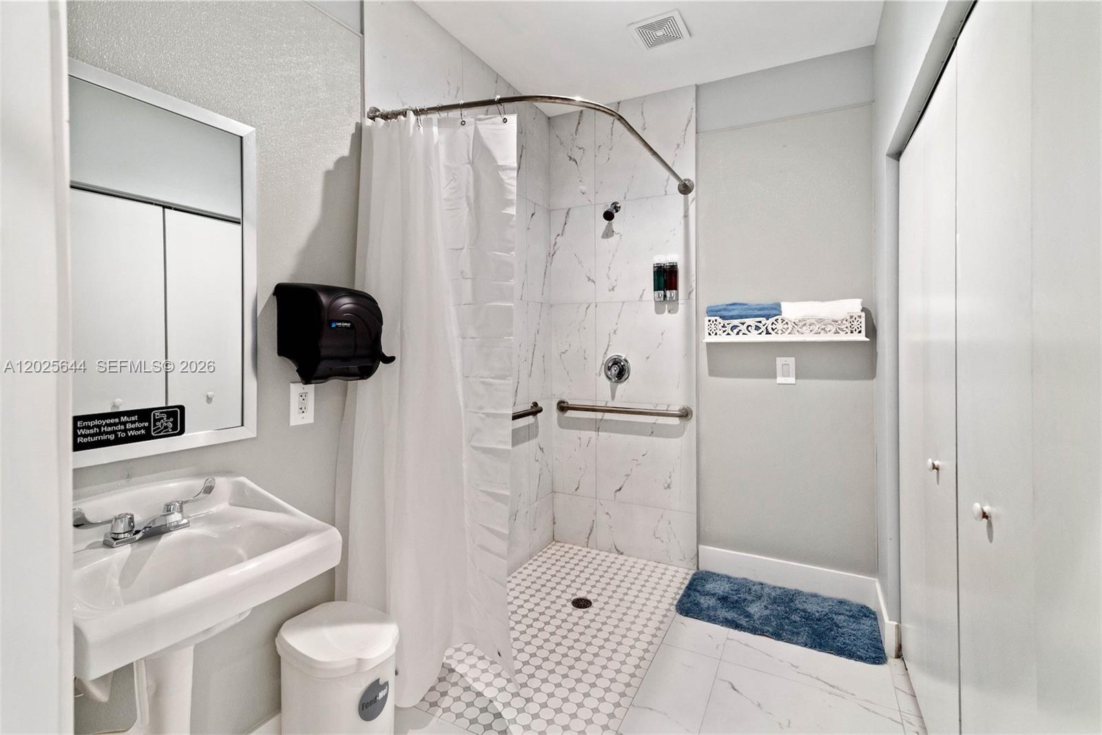 A small salon room features a white desk, a vanity with a mirror, and chairs — MIRAMAR, FL