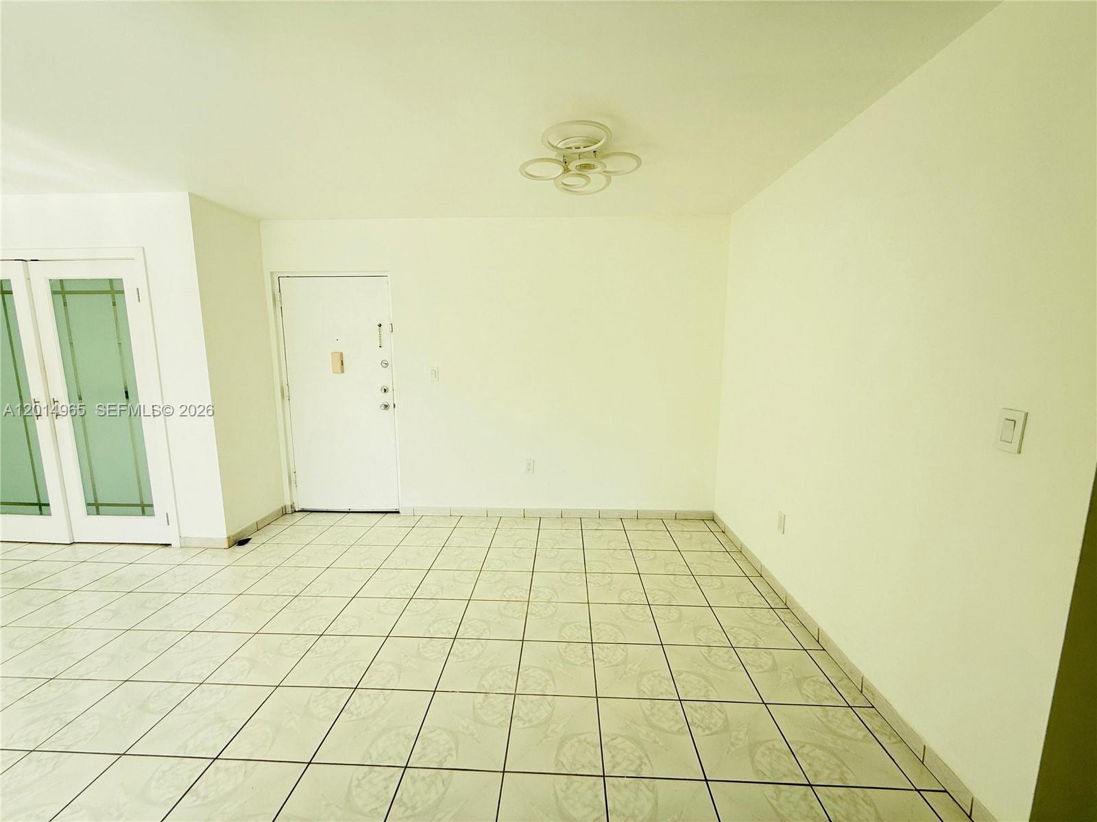 A room with white walls, a white door, and light-colored tiled flooring — 9440 W Flagler St # 305, Miami FL 33174, MIAMI, FL