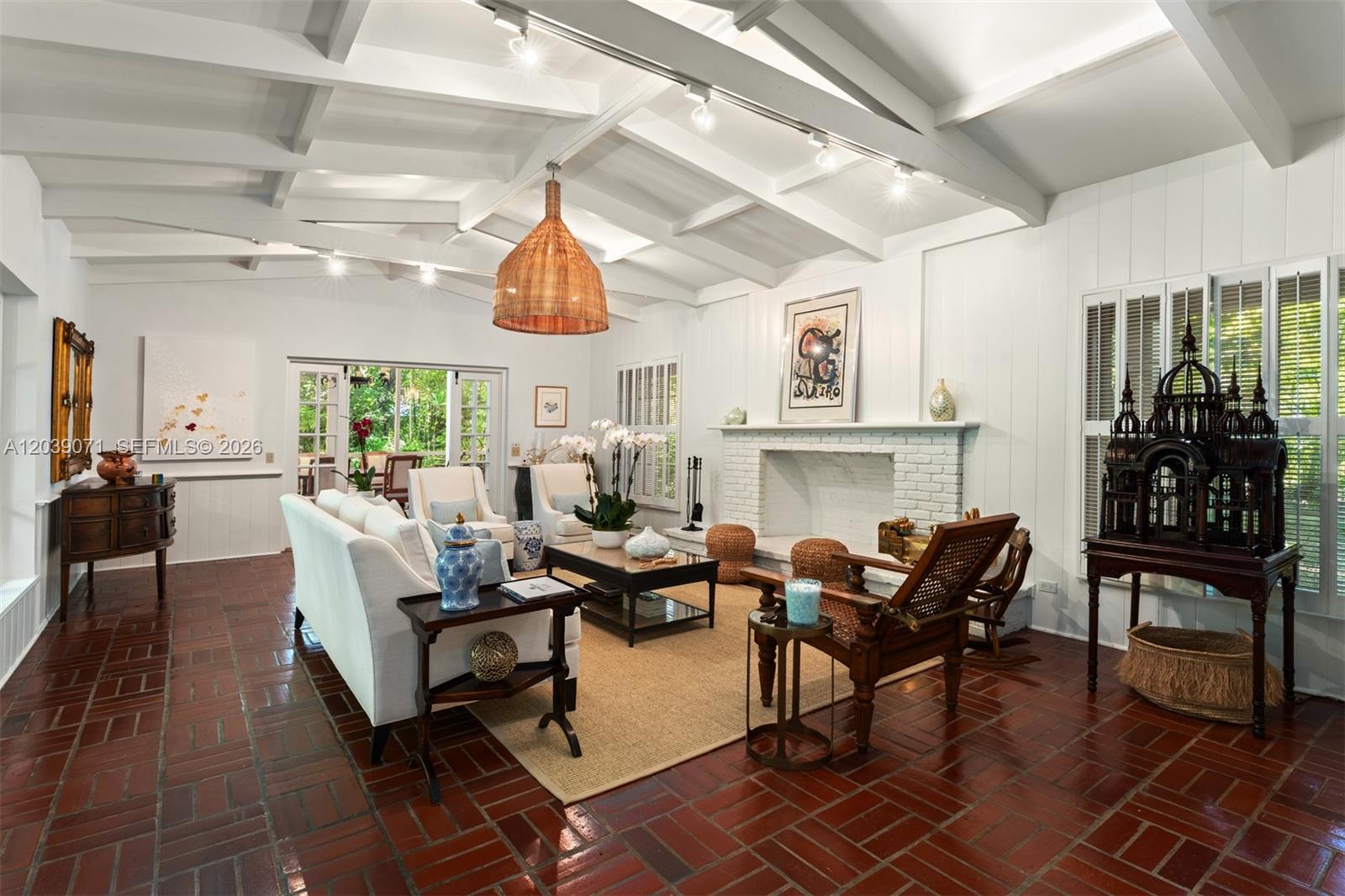 A living room features a white brick fireplace, vaulted beamed ceilings, and red tile flooring — 5950 SW 128th St, Pinecrest FL 33156, PINECREST, FL