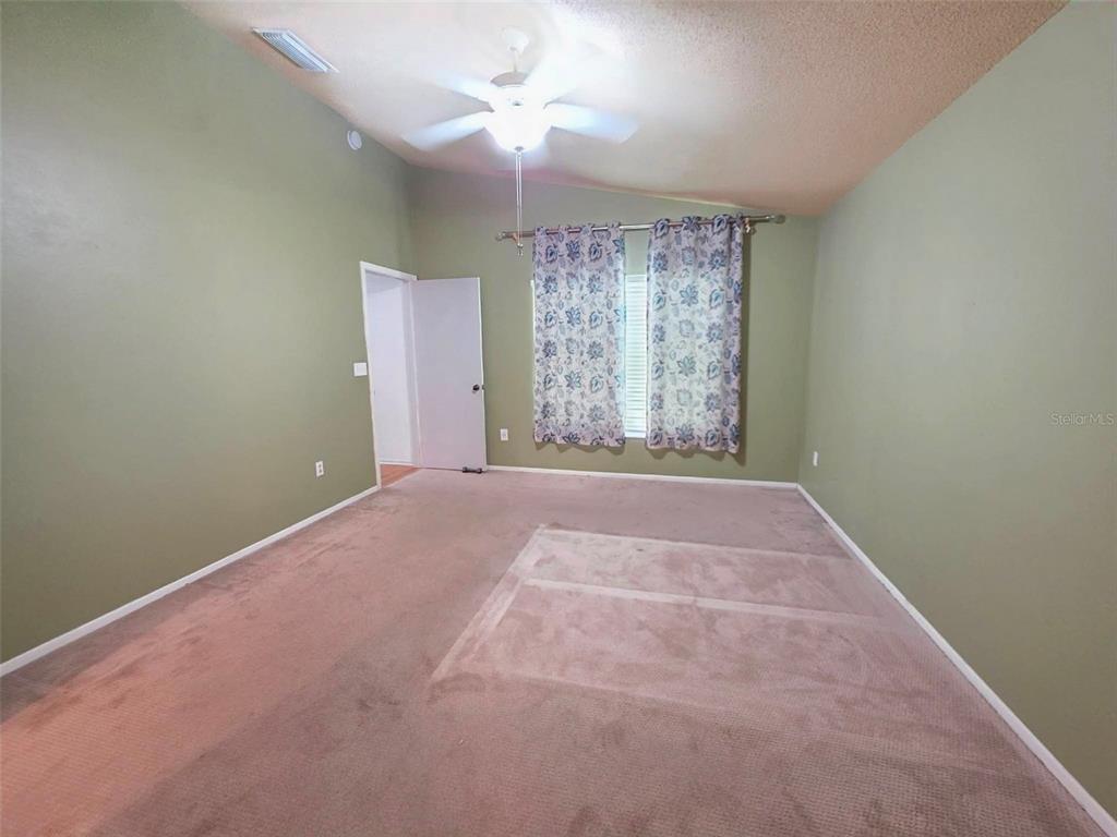 A bathroom features a white vanity, a mirror, a toilet, and a beach-themed shower curtain — 344 ALDRUP WAY, LAKE MARY, FL