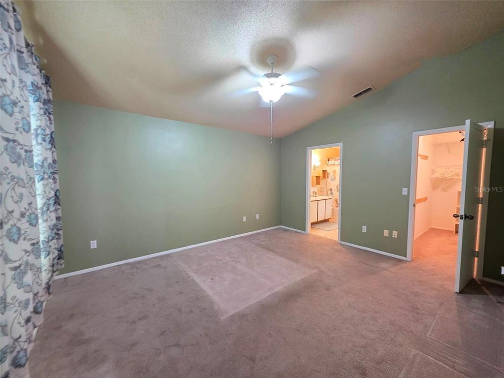 A closet with louvered doors and a wire shelf is set against a bright blue wall — 344 ALDRUP WAY, LAKE MARY, FL