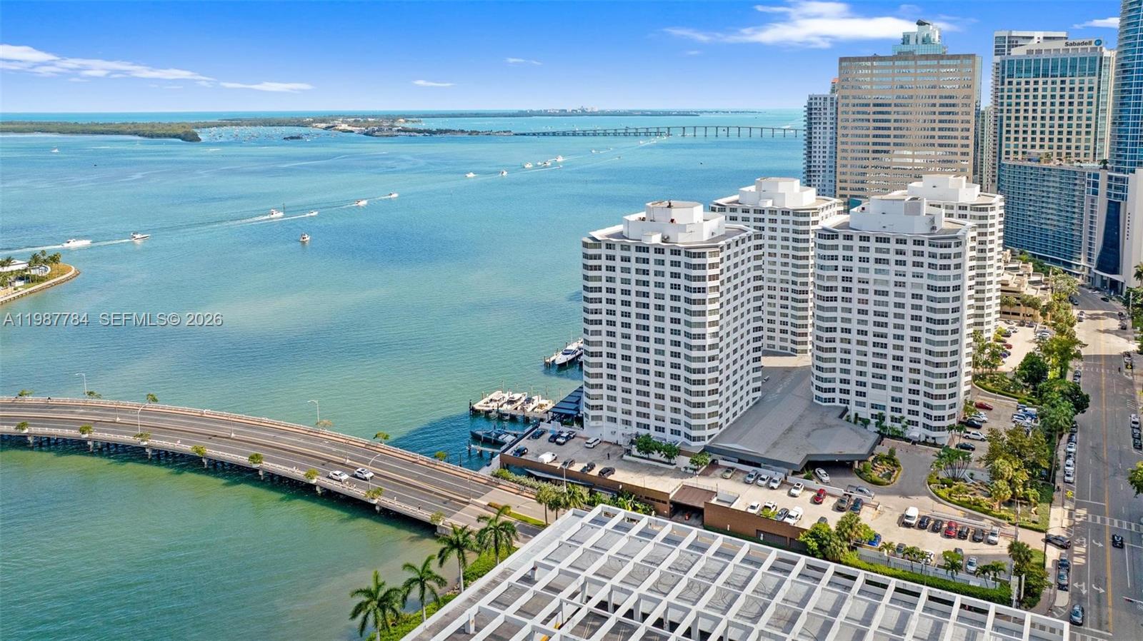 An aerial view shows high-rise apartment buildings situated next to a bridge and water — 801 Brickell Bay Dr # 361, Miami FL 33131, MIAMI, FL
