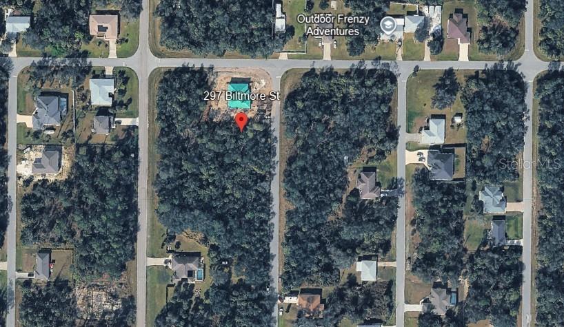This aerial map shows a residential lot with a house under construction among wooded surroundings — 297 BILTMORE STREET, PORT CHARLOTTE, FL
