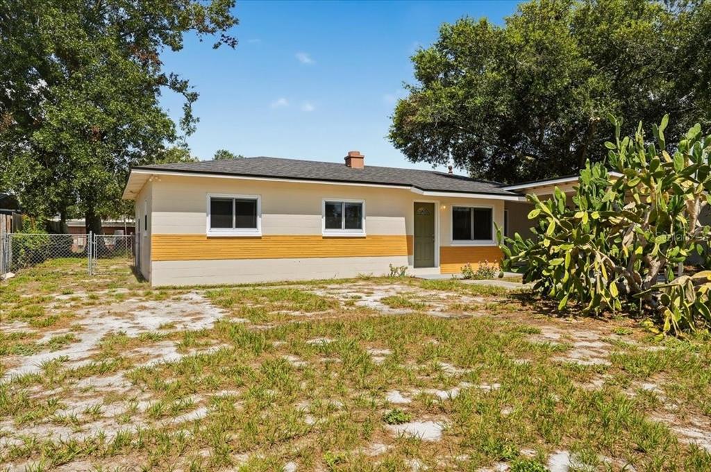 A single-story house with a yellow and cream exterior sits on a grassy lot — 813 ELLERBE WAY, LAKELAND, FL