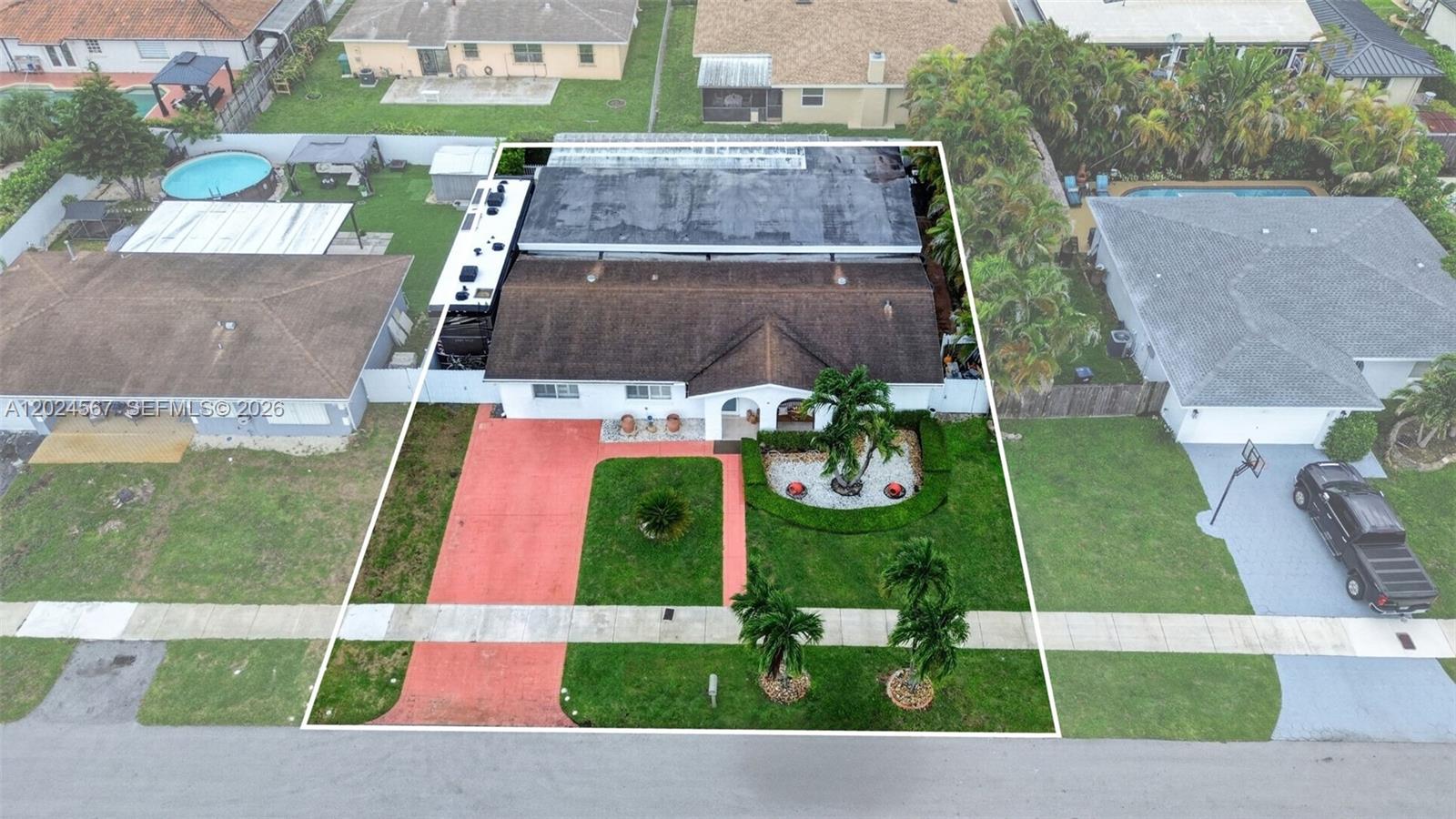 An aerial view shows a single-story house with a red driveway and a flat roof — 13463 SW 66th Ter, Miami FL 33183, MIAMI, FL