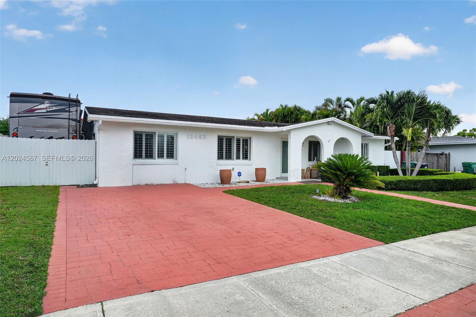 A white single-story house with a red brick driveway and arched entryway — 13463 SW 66th Ter, Miami FL 33183, MIAMI, FL