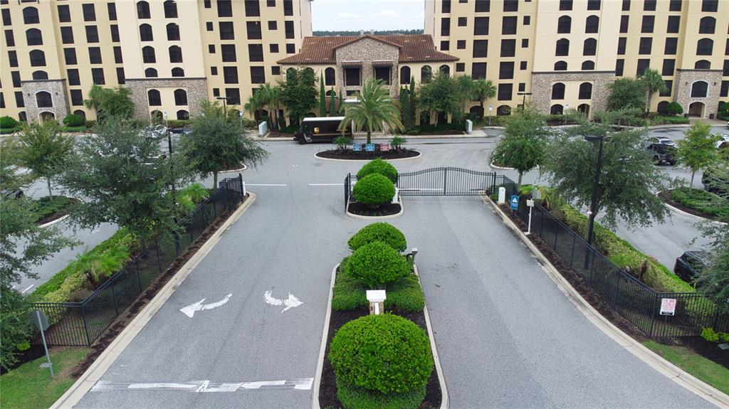 An aerial view shows a gated entrance to a large apartment complex with landscaped medians — 16300 COUNTY ROAD 455 UNIT 307, MONTVERDE, FL