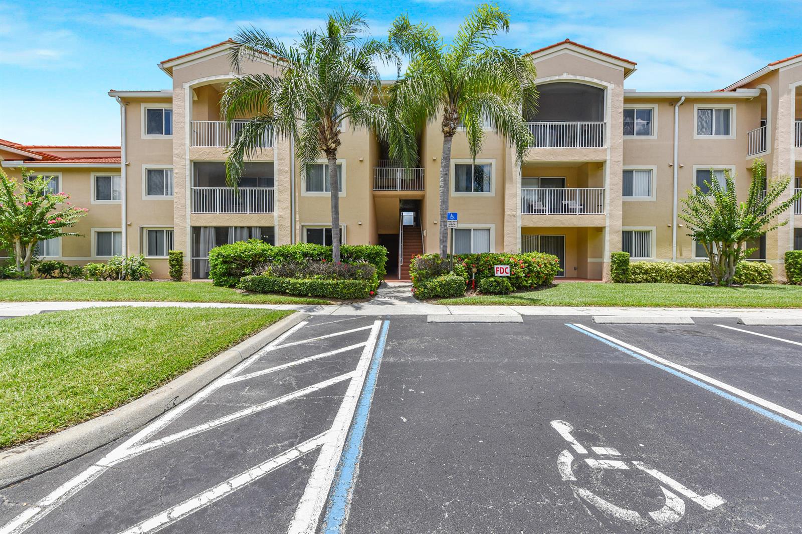 A three-story apartment building with a parking lot and a handicap space in front — 1590 S 42nd Circle # 106, Vero Beach FL 32967, VERO BEACH, FL