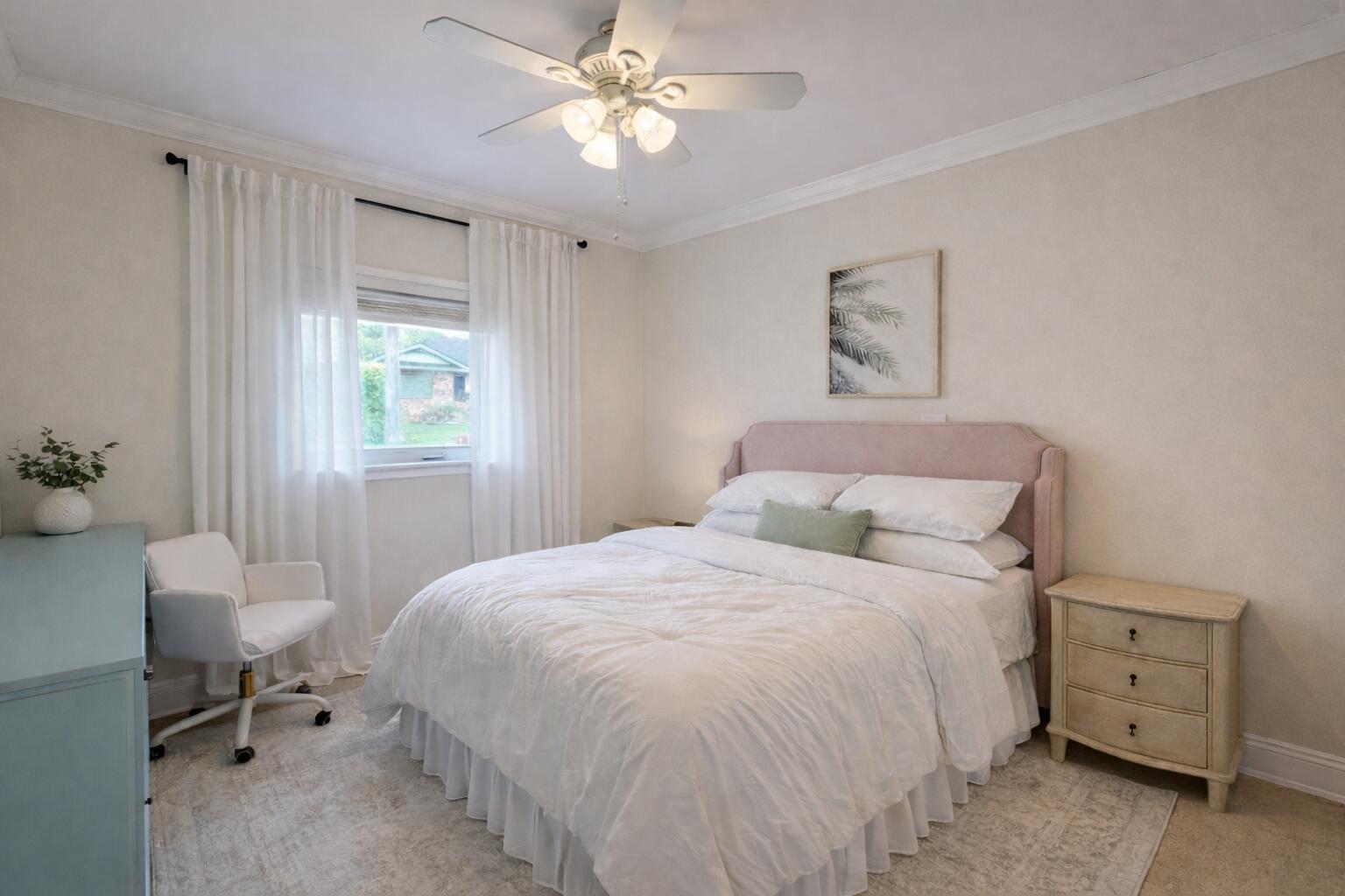 A bedroom features a pink upholstered headboard, white bedding, a ceiling fan, and a window — 1827 Len Drive, North Palm Beach FL 33408, NORTH PALM BEACH, FL