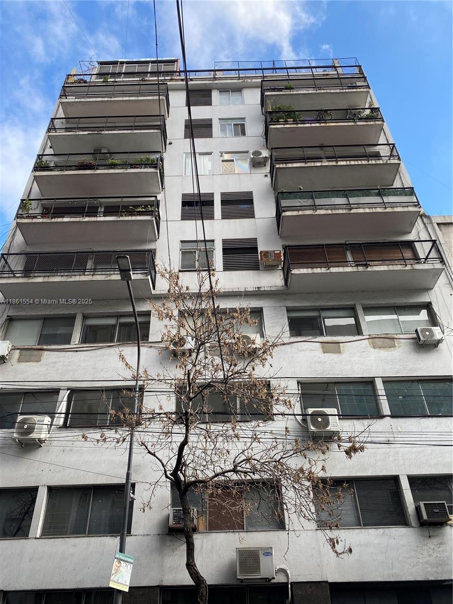 A low-angle view of a multi-story apartment building with balconies and exterior air conditioning units — Riobamba 72 Buenos Aires Riobamba 72 Buenos Aires # 8, FL 72, FL