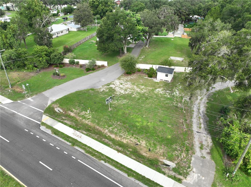 An aerial view shows a vacant lot with a small shed next to a paved road — 37351 CARRINGER ROAD, DADE CITY, FL