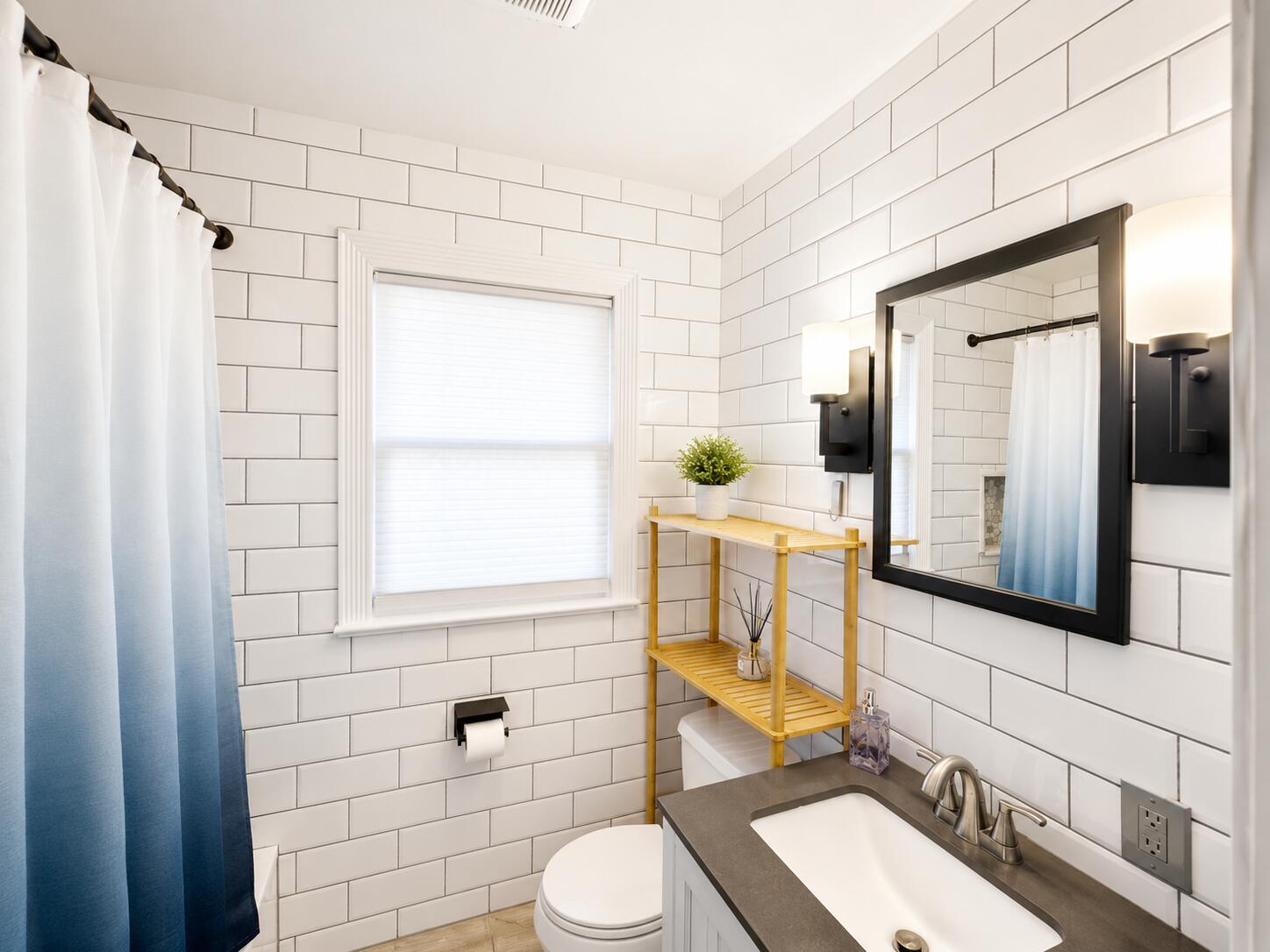 A bathroom features white subway tile walls, a blue ombre shower curtain, and a vanity — 322 S L Street, FL 33460, FL