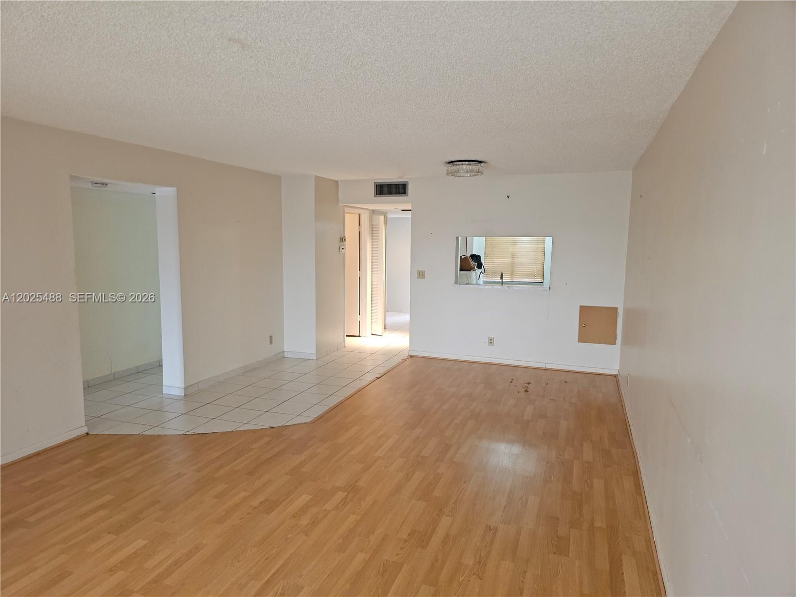 An unfurnished room features a combination of light wood-look flooring and white tile — 7270 Ashford Pl # 308, Delray Beach FL 33446, DELRAY BEACH, FL
