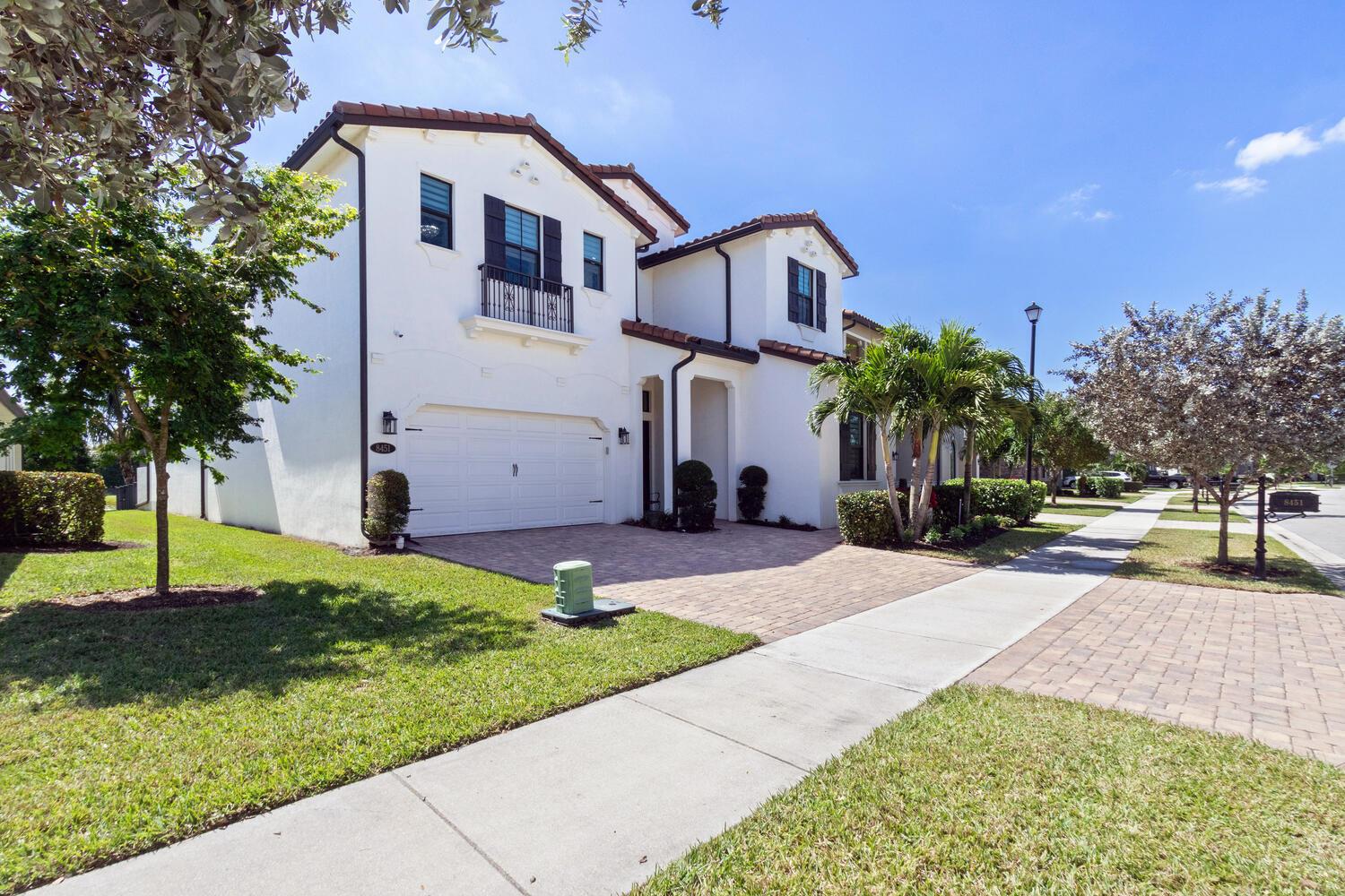 A two-story white stucco house with a tiled roof and a paved driveway — 8451 Grand Prix Lane, Boynton Beach FL 33472, BOYNTON BEACH, FL