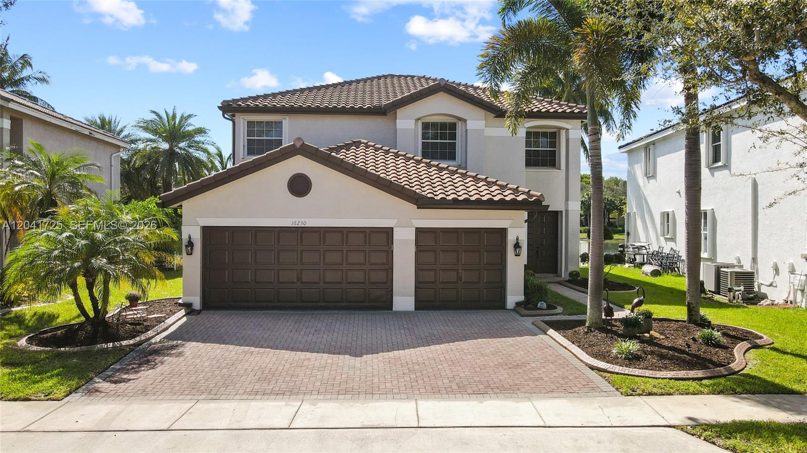 A two-story house with a brown tile roof, two-car garage, and paved driveway — 16230 SW 21st St, Miramar FL 33027, MIRAMAR, FL