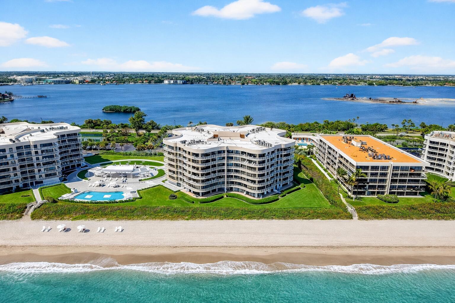 An aerial view of three beachfront apartment buildings with a swimming pool and sandy beach — 3400 S Ocean Boulevard # I, Palm Beach FL 33480, PALM BEACH, FL