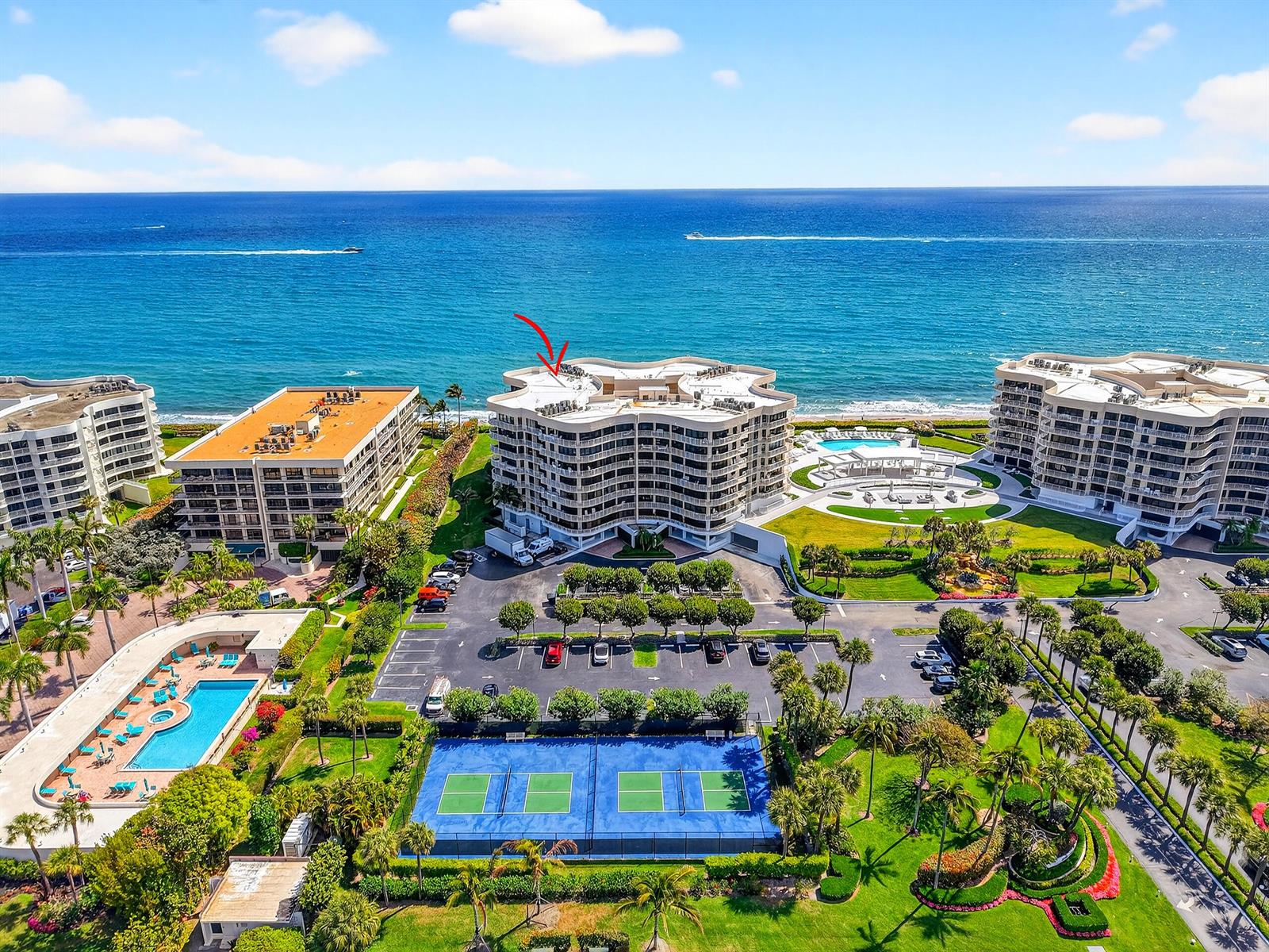 An aerial view shows a multi-story beachfront condominium complex with a pool and tennis courts — 3400 S Ocean Boulevard # I, Palm Beach FL 33480, PALM BEACH, FL