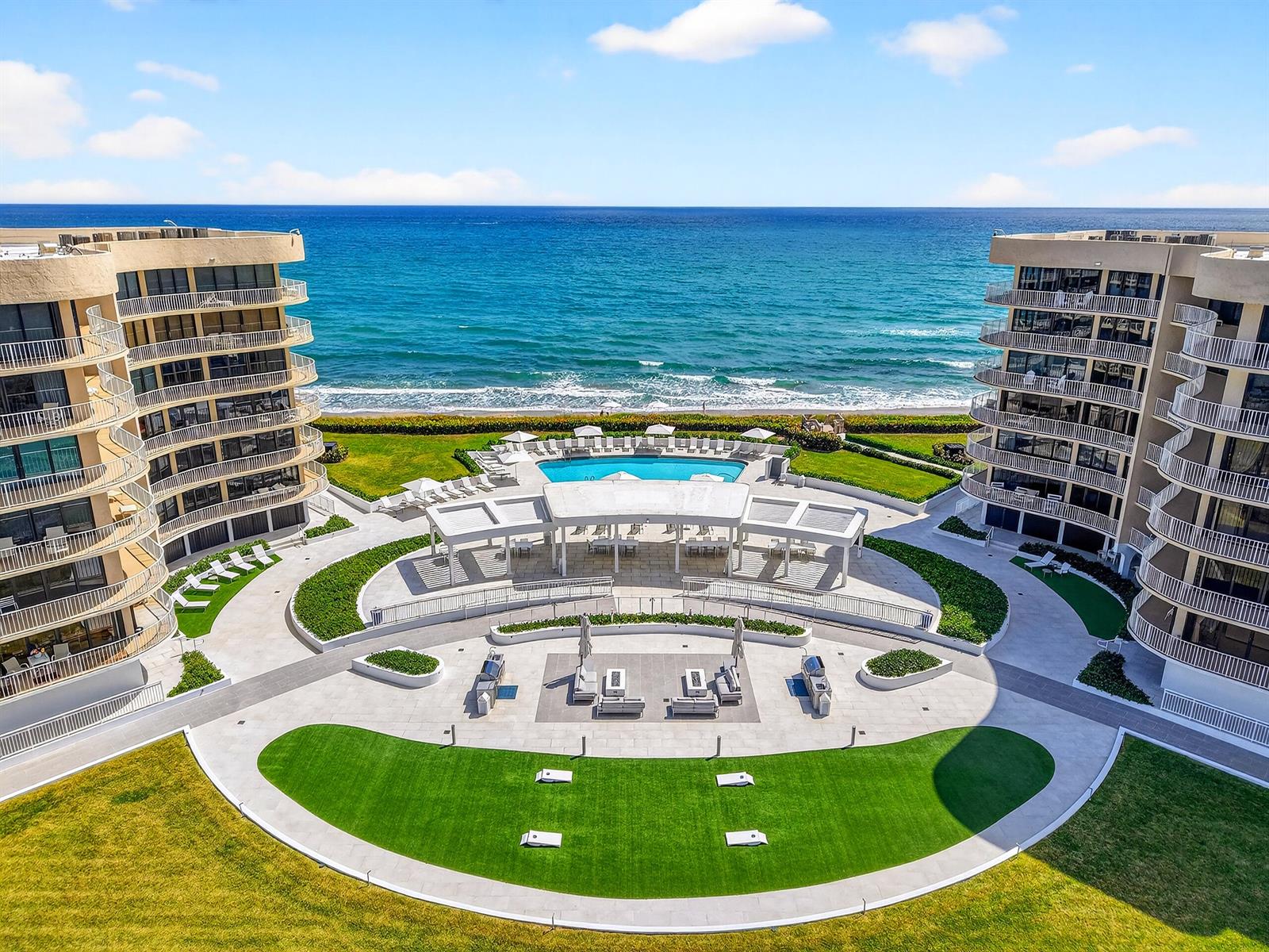An aerial view shows two curved apartment buildings flanking a pool, patio, and lawn area — 3400 S Ocean Boulevard # I, Palm Beach FL 33480, PALM BEACH, FL