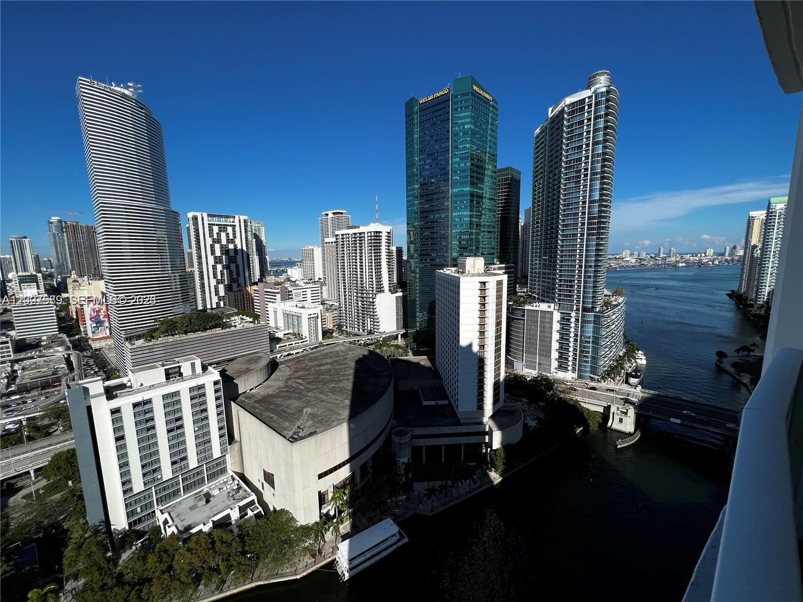 An elevated view of the Miami skyline featuring skyscrapers, a river, and urban architecture — 31 SE 5th St # 3002, Miami FL 33131, MIAMI, FL