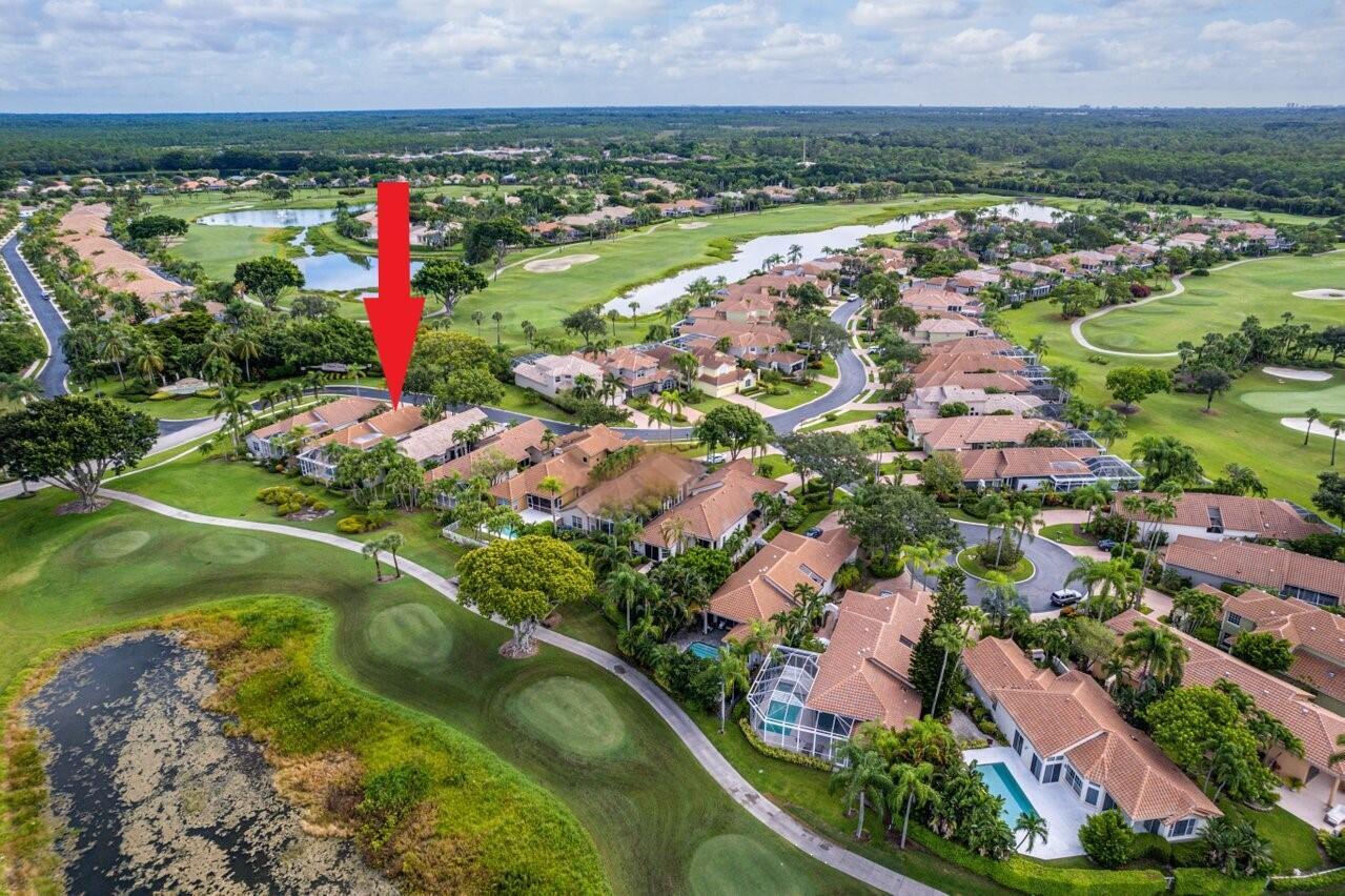 An aerial view shows a residential neighborhood with houses, swimming pools, and a golf course — 10414 Osprey Trace, West Palm Beach FL 33412, WEST PALM BEACH, FL