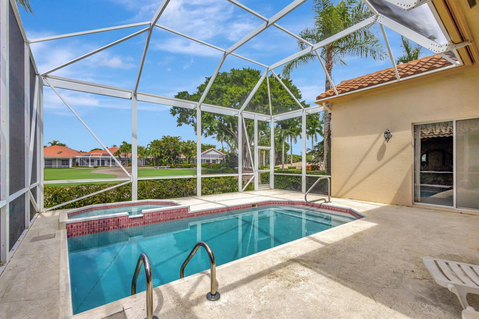 A screened-in pool and spa area with a view of a golf course — 10414 Osprey Trace, West Palm Beach FL 33412, WEST PALM BEACH, FL