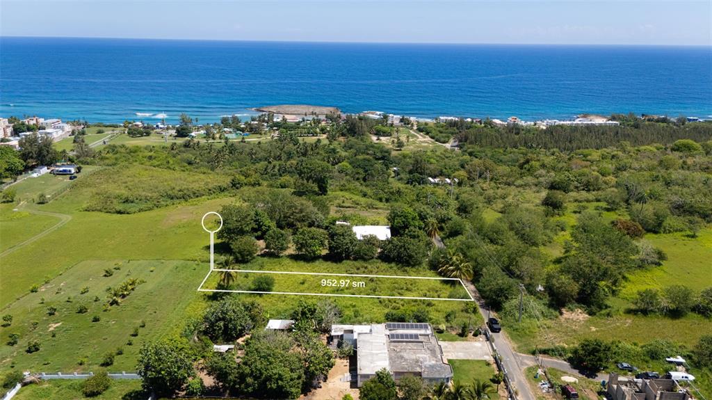 An aerial view shows a rectangular plot of land marked with 952.97 sm near the ocean — CARR 459 Km 12.5 JOBOS WARD, ISABELA, PR