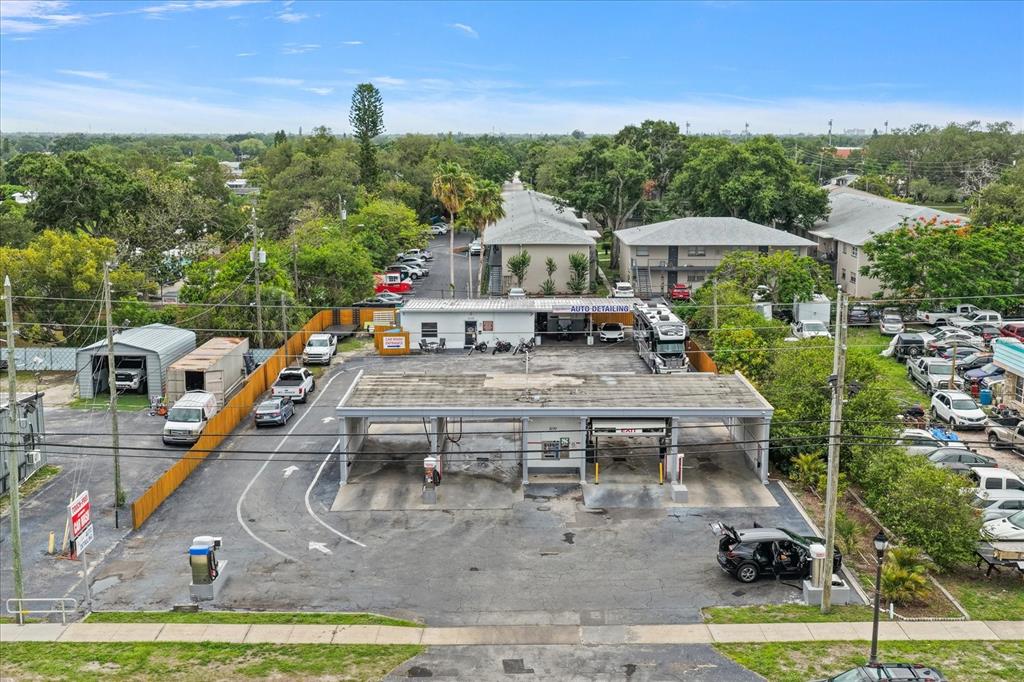 An aerial view of a car wash facility with multiple bays and an adjacent parking lot — 6170 54TH AVENUE N, KENNETH CITY, FL