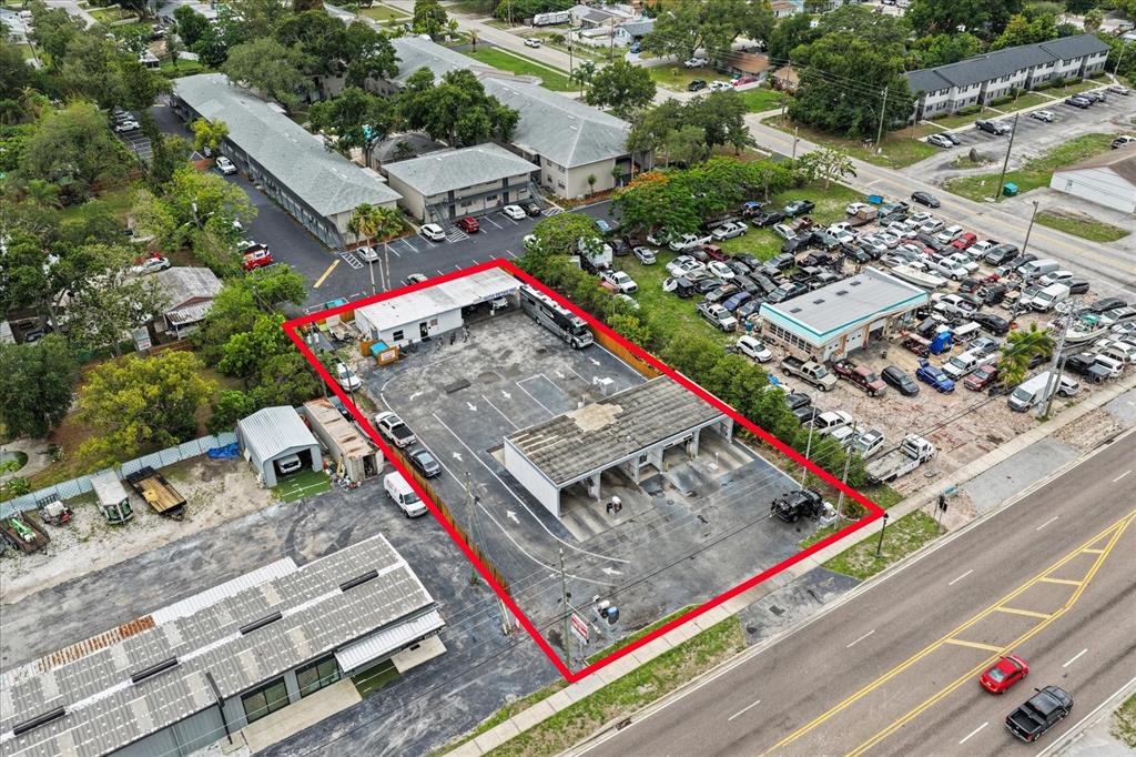 An aerial view shows a car wash facility outlined in red on a paved lot — 6170 54TH AVENUE N, KENNETH CITY, FL